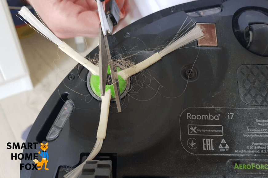 Seitenbürste des Roomba i7+ wird mit Hilfe einer Schere von Haaren befreit